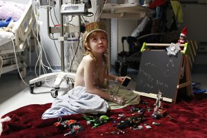 After 10 days in the pediatric intensive care unit fighting a severe bacterial infection, Rowan and his mother, Carrie, celebrate New Year's Eve at Methodist Children's Hospital. Carrie made confetti out of construction paper and they made a list of resolutions.